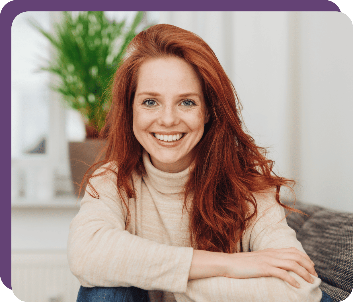 happy young woman with bright red hair smiles thanks to reduce pain due to TMJ