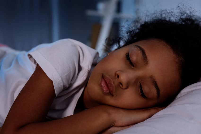 a child asleep in bed